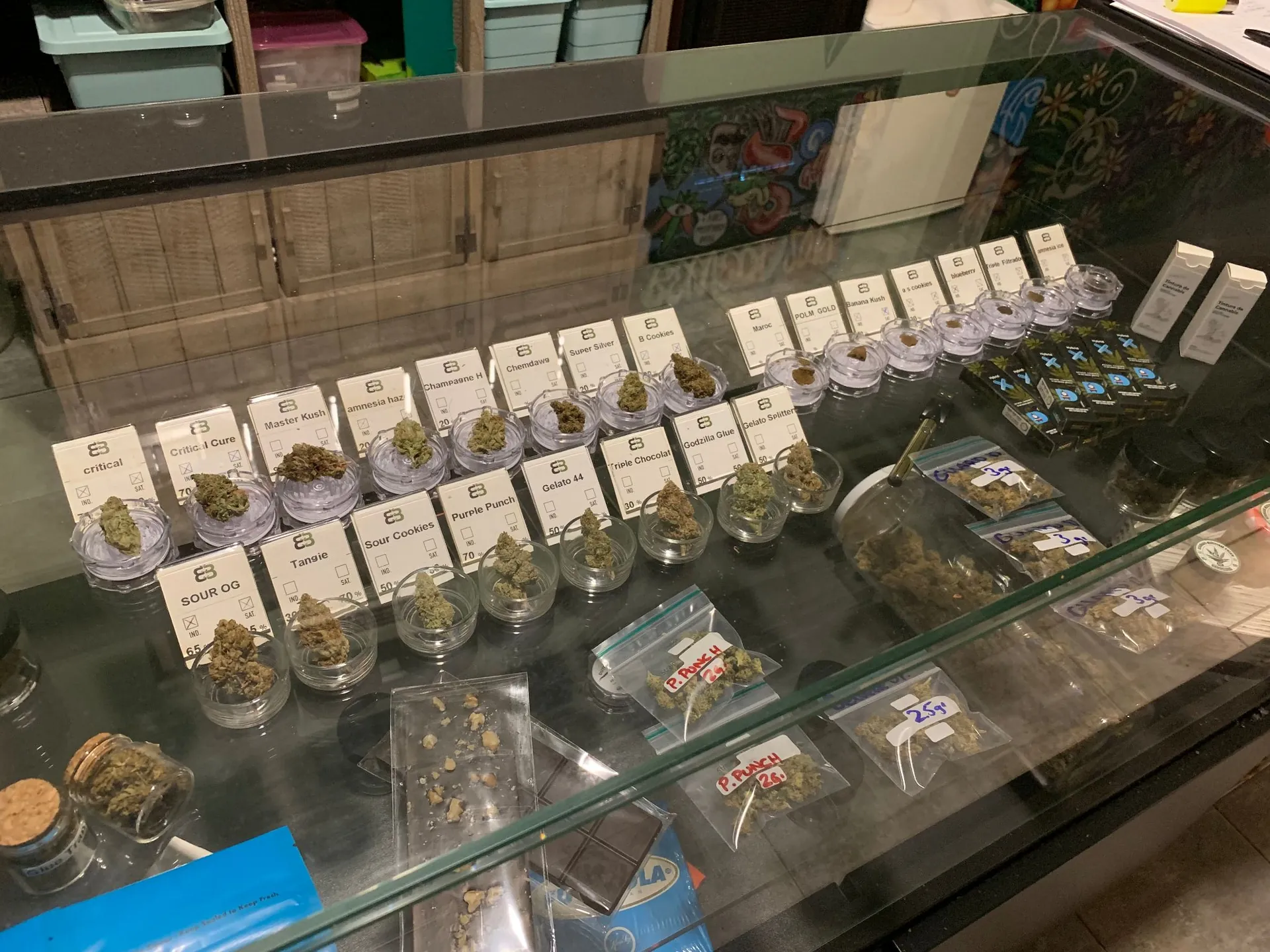 jars of different cannabis varieties in a coffee-shop-style dispensary